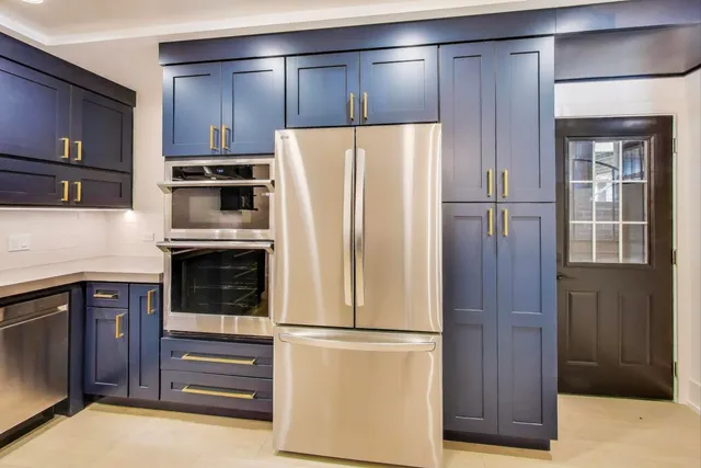 a kitchen with cabinets and stainless steel appliances