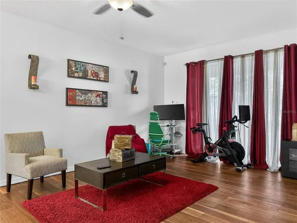 a living room with furniture and wooden floor
