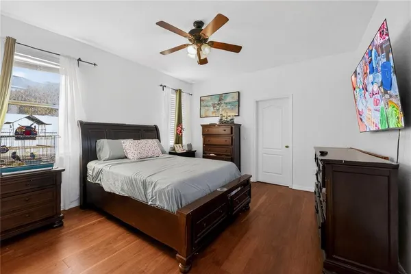 a bedroom with a bed and a painting on the wall