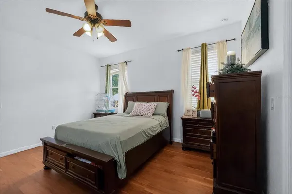 a bedroom with a bed dresser and a window
