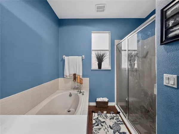 a bathroom with a bathtub and shower