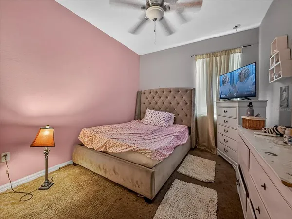 a bedroom with a bed couch and window