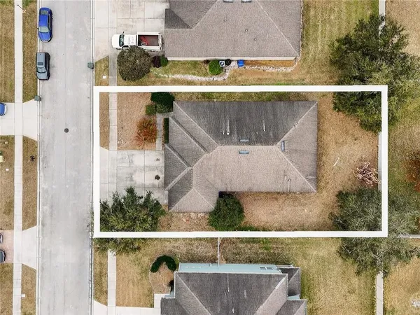 an aerial view of a house with a yard