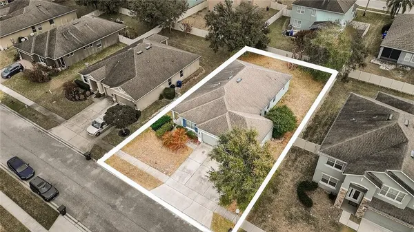 an aerial view of a house with a yard