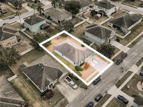 a view of a street with a building and trees in the background