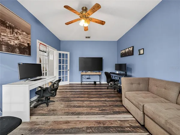 a living room with furniture and a flat screen tv