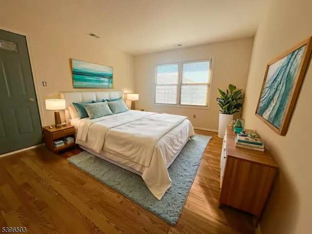 a bedroom with bed and a large window