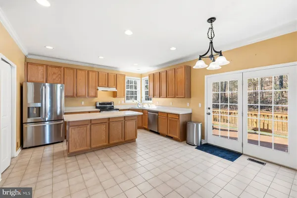 a kitchen with stainless steel appliances granite countertop a refrigerator and a sink