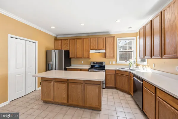 a kitchen with stainless steel appliances granite countertop a refrigerator sink stove and microwave