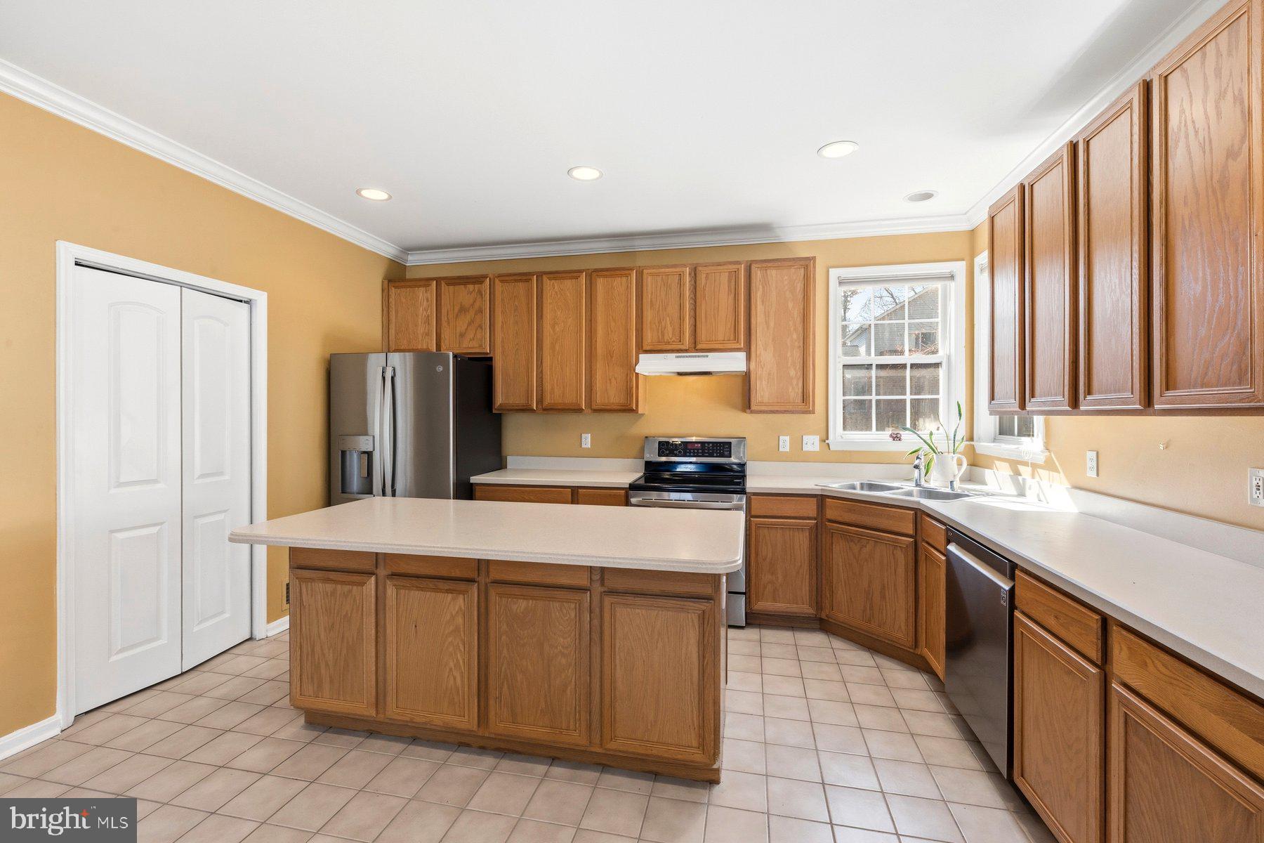 7810 Grandison Way Severn, MD 21144 - Photo 12 of 50 a kitchen with stainless steel appliances granite countertop a refrigerator sink stove and microwave