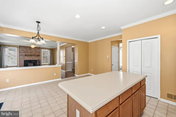 a view of kitchen with granite countertop cabinets and refrigerator