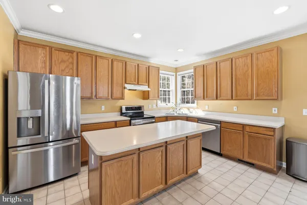 a kitchen with stainless steel appliances granite countertop a refrigerator sink and cabinets