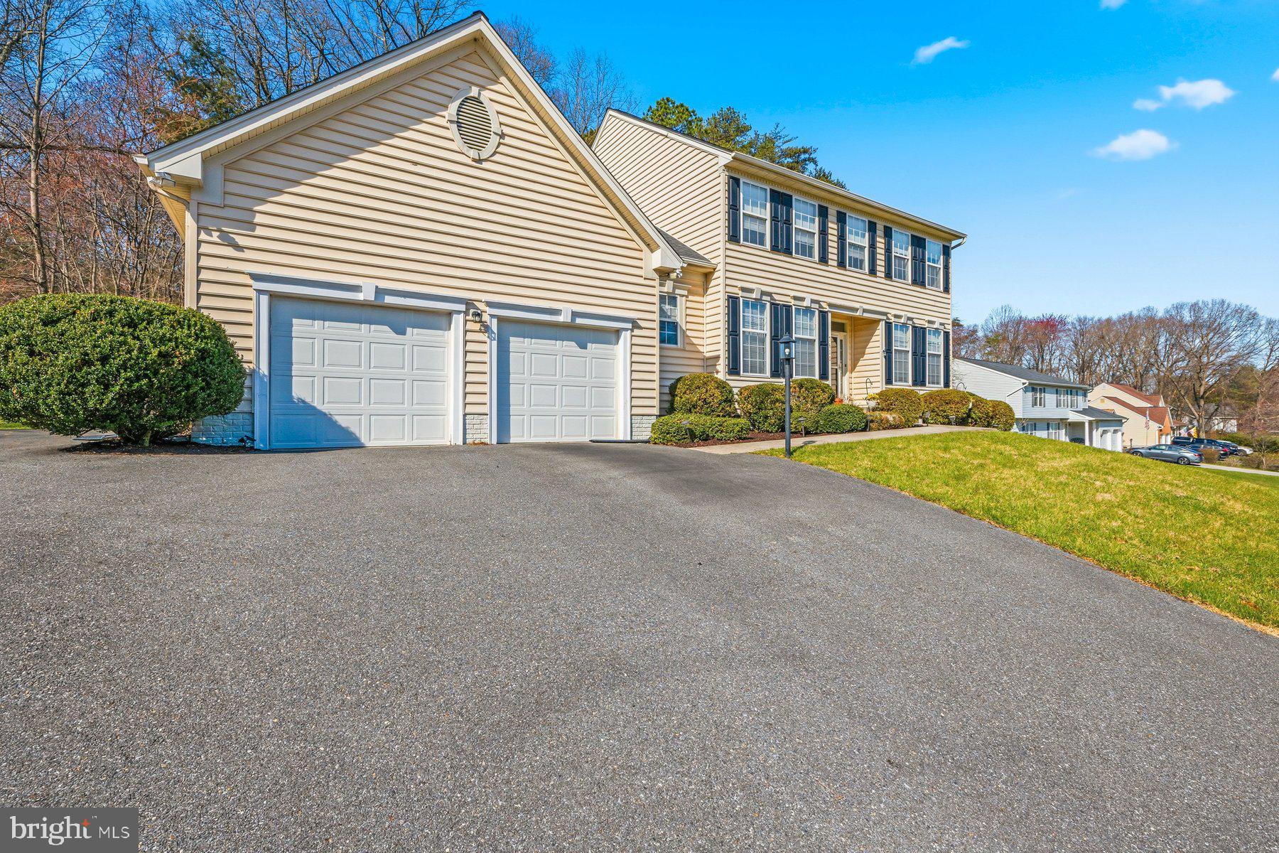 7810 Grandison Way Severn, MD 21144 - Photo 2 of 50 a front view of a house with a yard and garage