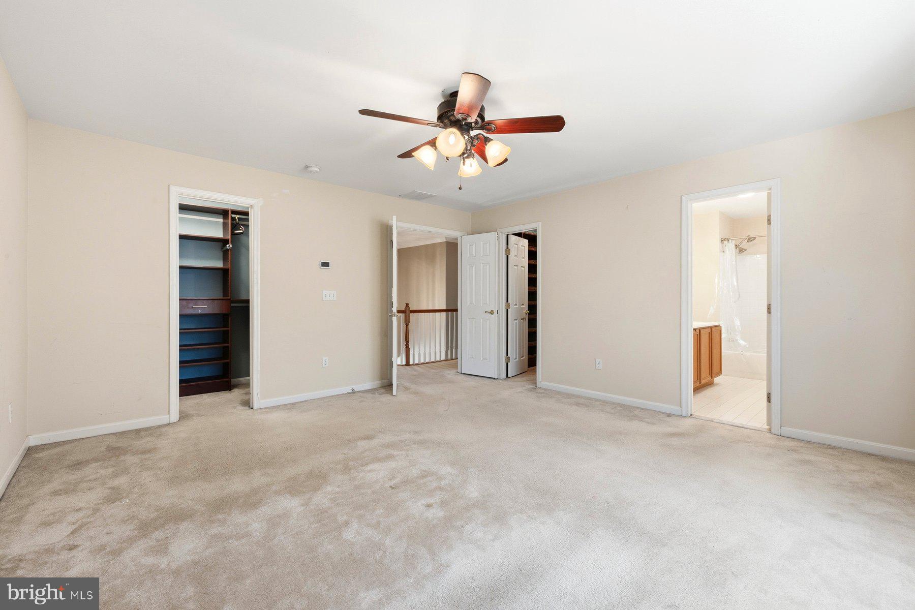 7810 Grandison Way Severn, MD 21144 - Photo 30 of 50 an empty room with closet and a ceiling fan