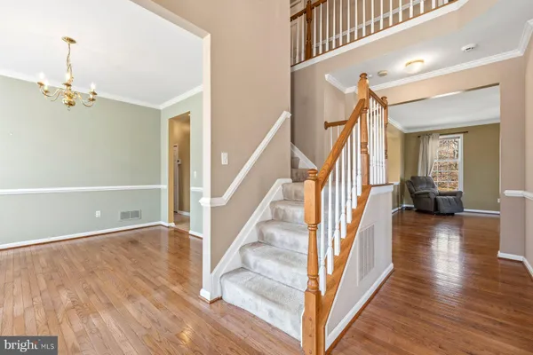 a view of a hallway view with wooden floor and staircase