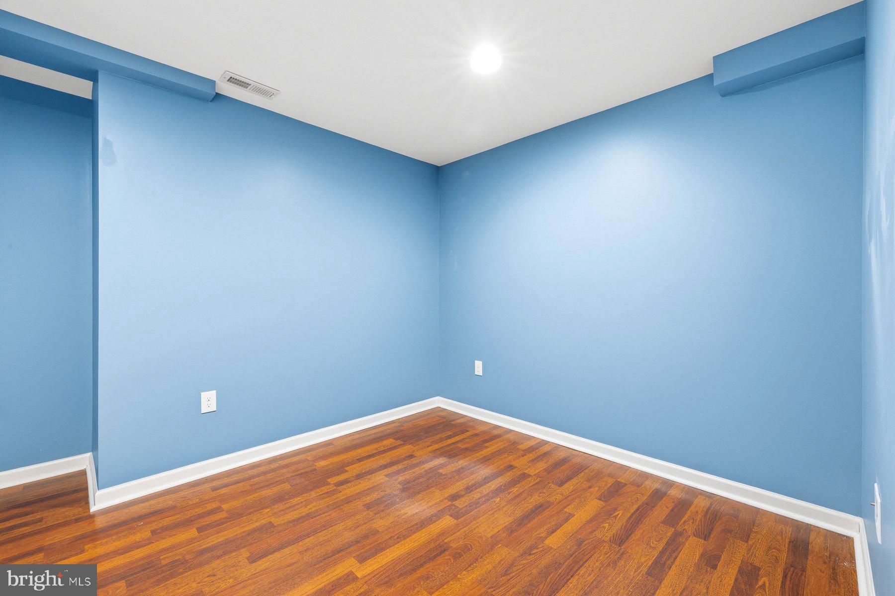 7810 Grandison Way Severn, MD 21144 - Photo 39 of 50 a view of empty room with wooden floor