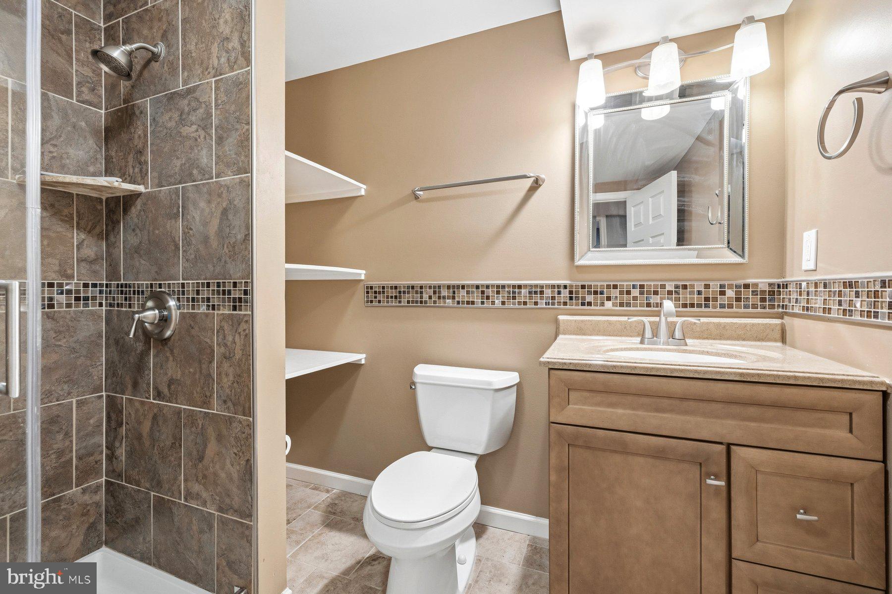 7810 Grandison Way Severn, MD 21144 - Photo 43 of 50 a bathroom with a toilet sink and shower