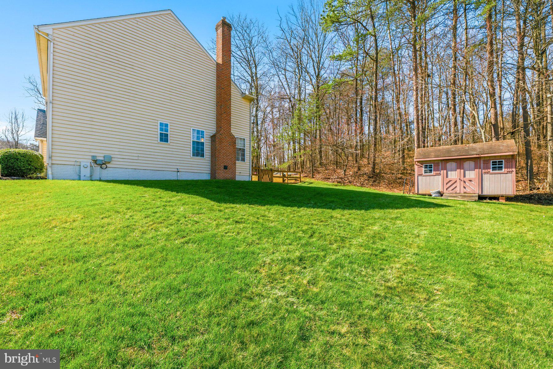 7810 Grandison Way Severn, MD 21144 - Photo 50 of 50 a view of a backyard with plants and large trees