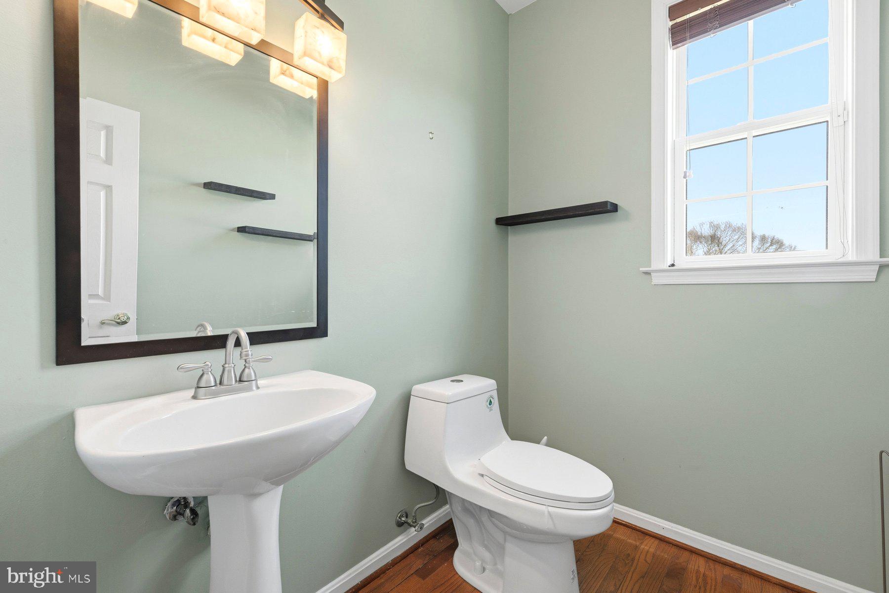 7810 Grandison Way Severn, MD 21144 - Photo 8 of 50 a bathroom with a toilet sink and mirror