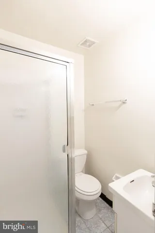 a white toilet sitting next to a bathroom sink