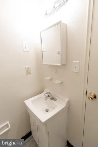 a bathroom with a sink a mirror and vanity