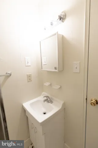 a bathroom with a sink and mirror