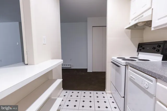 a kitchen with a refrigerator and a stove
