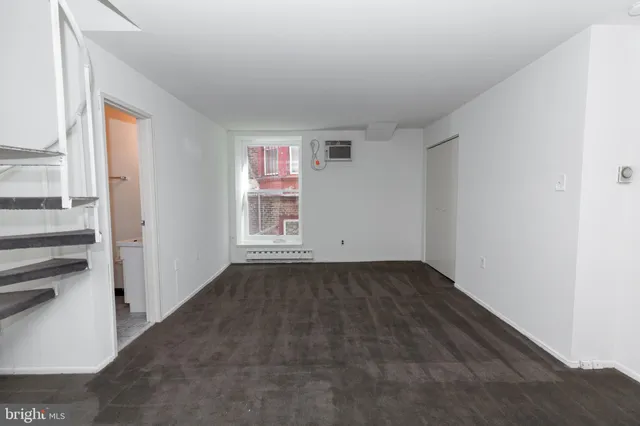 a view of a room with wooden floor and windows