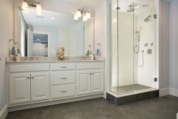 25 Patton Road Wellesley, MA 02482 - Photo 11 of 20 a bathroom with a double vanity sink a large mirror a bathtub and