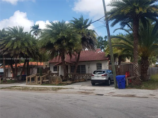 a front view of a house with a garden and a yard