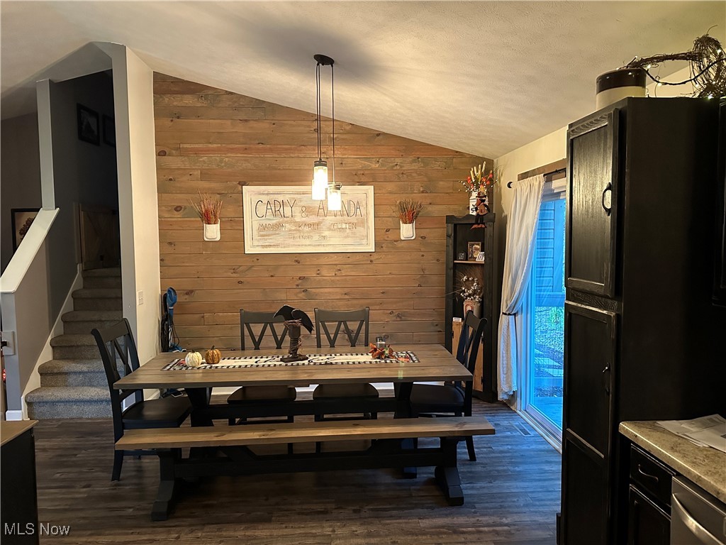 58440 Wharton Road Barnesville, OH 43713 - Photo 6 of 38 Dining room featuring wooden walls, lofted ceiling, and dark wood-type flooring