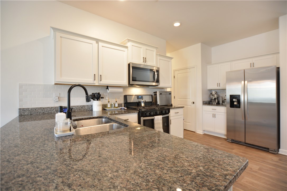 242 Hillendale Way Pelzer, SC 29669 - Photo 13 of 19 This functional kitchen features ample counter space, modern appliances, and a convenient layout.