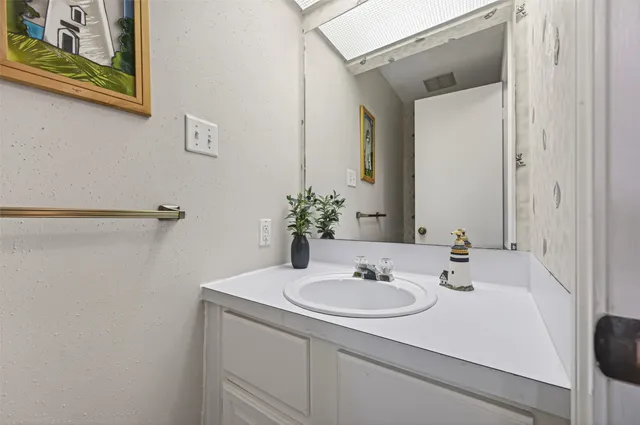 a bathroom with a sink and a mirror