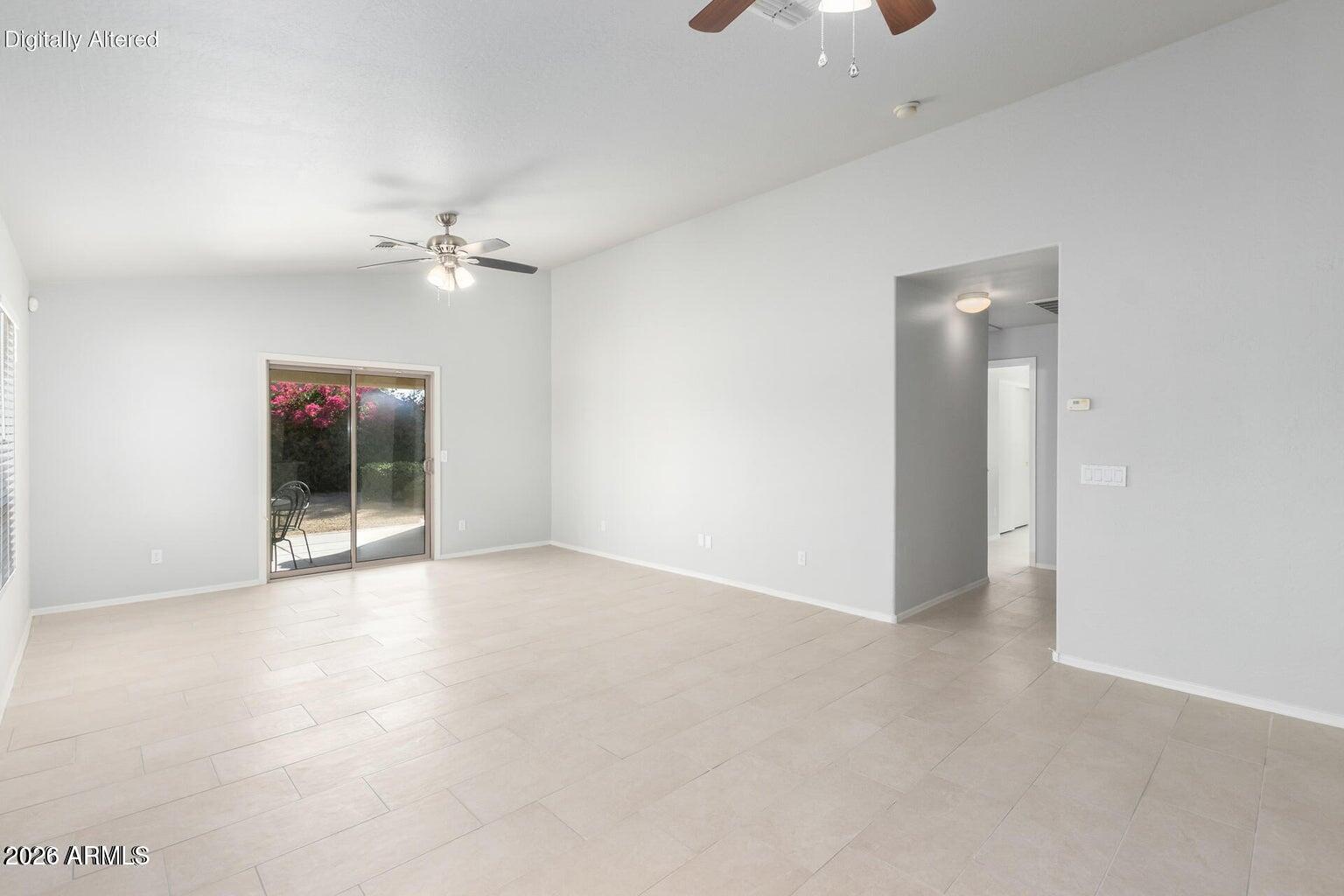 17715 West Redfield Road Surprise, AZ 85388 - Photo 10 of 36 an empty room with chandelier fan and windows