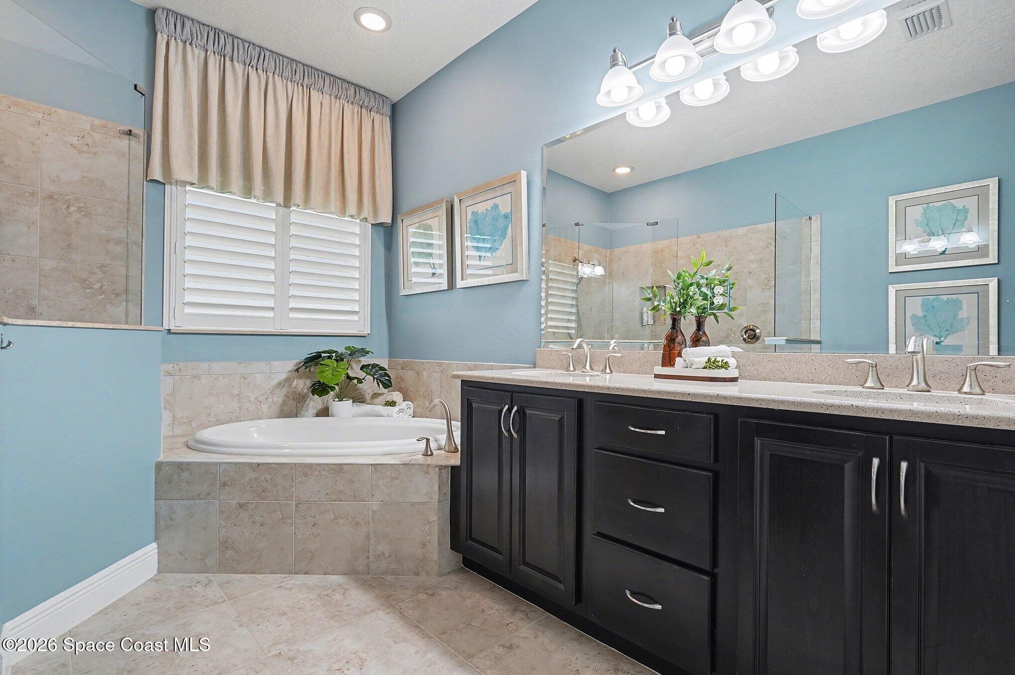 4310 Alamanda Key Drive Melbourne, FL 32901 - Photo 14 of 43 a bathroom with a sink double vanity and a mirror
