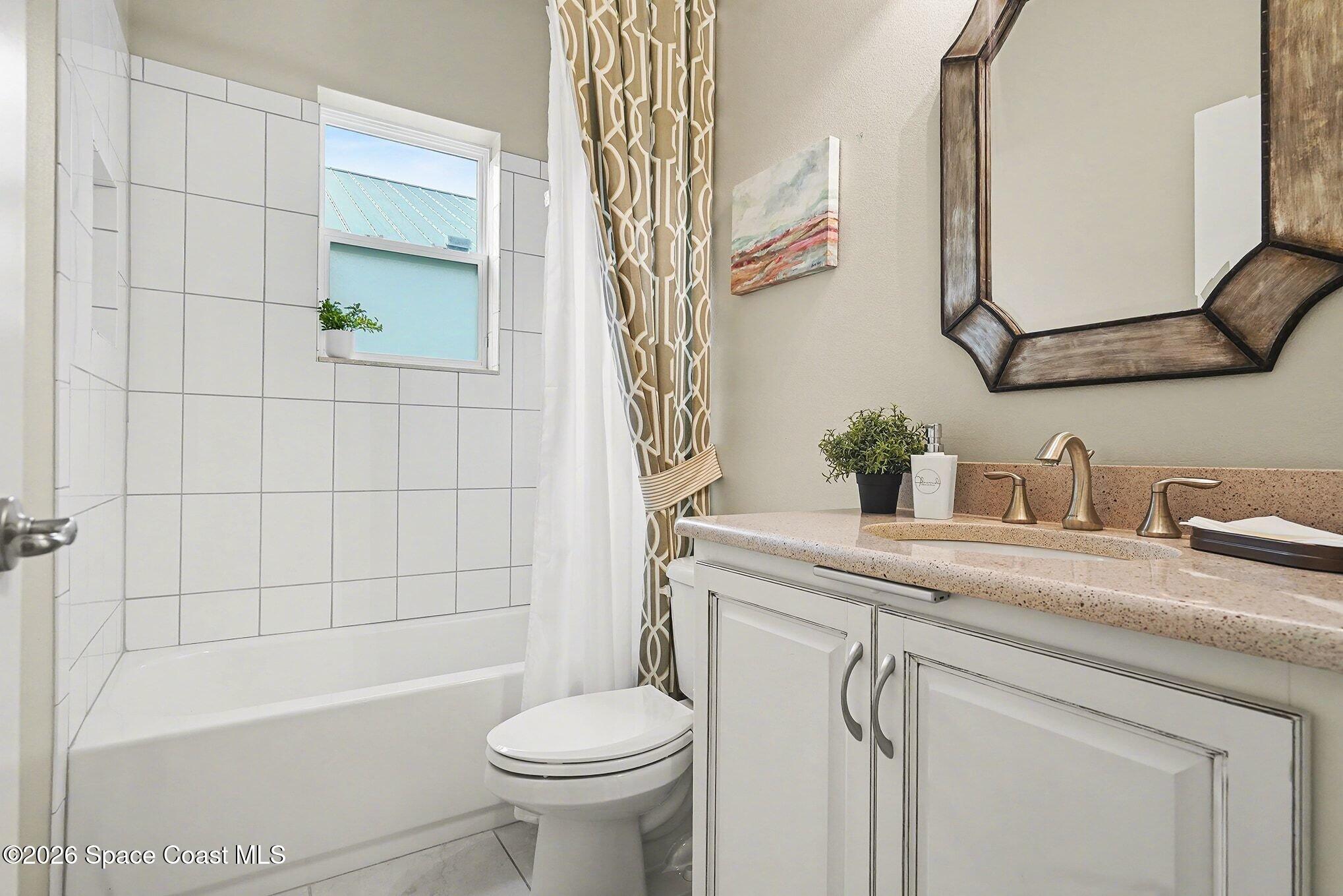 4310 Alamanda Key Drive Melbourne, FL 32901 - Photo 15 of 43 a bathroom with a sink a toilet and bathtub