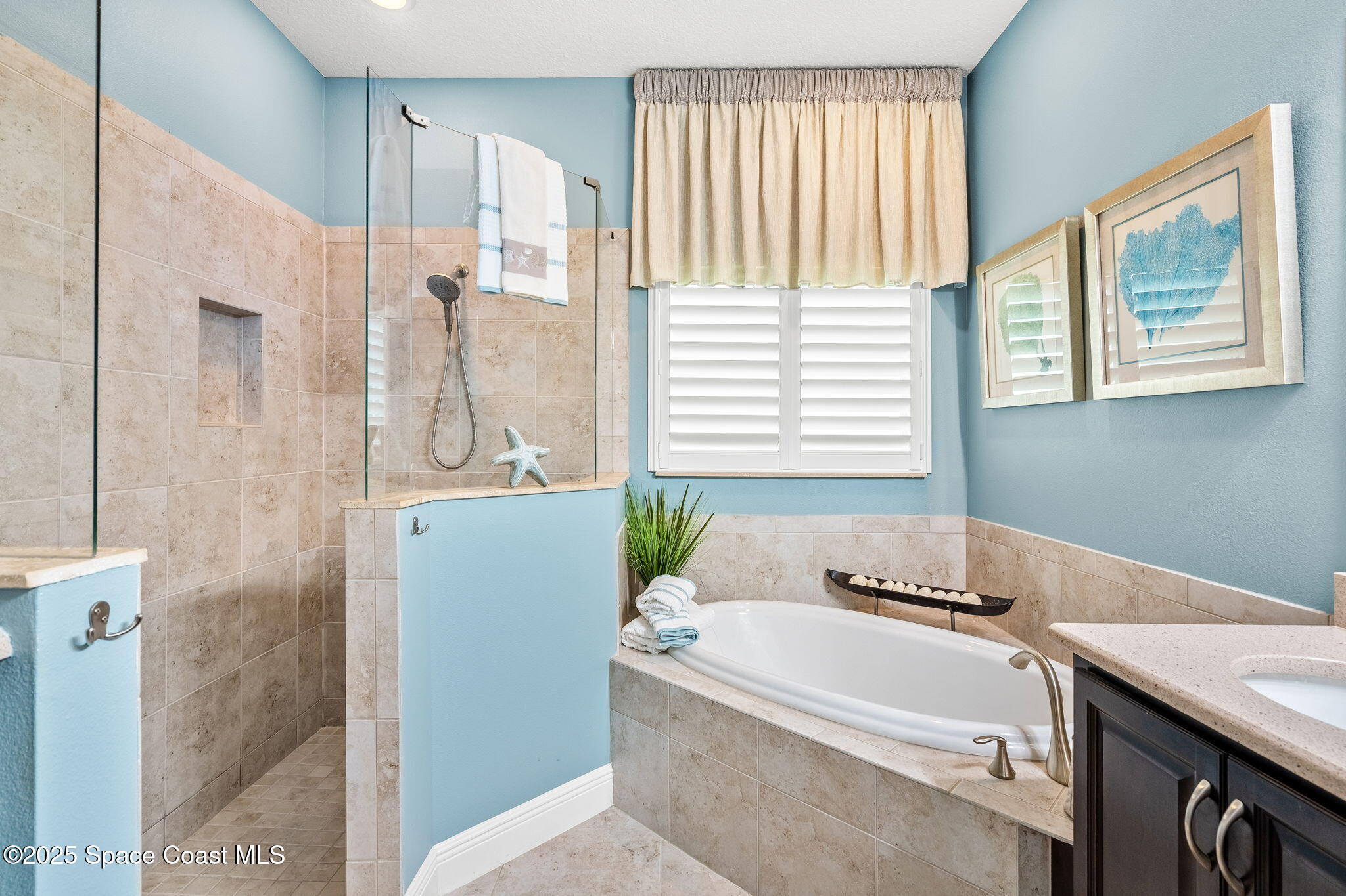 4310 Alamanda Key Drive Melbourne, FL 32901 - Photo 17 of 43 a bathroom with a tub sink and mirror