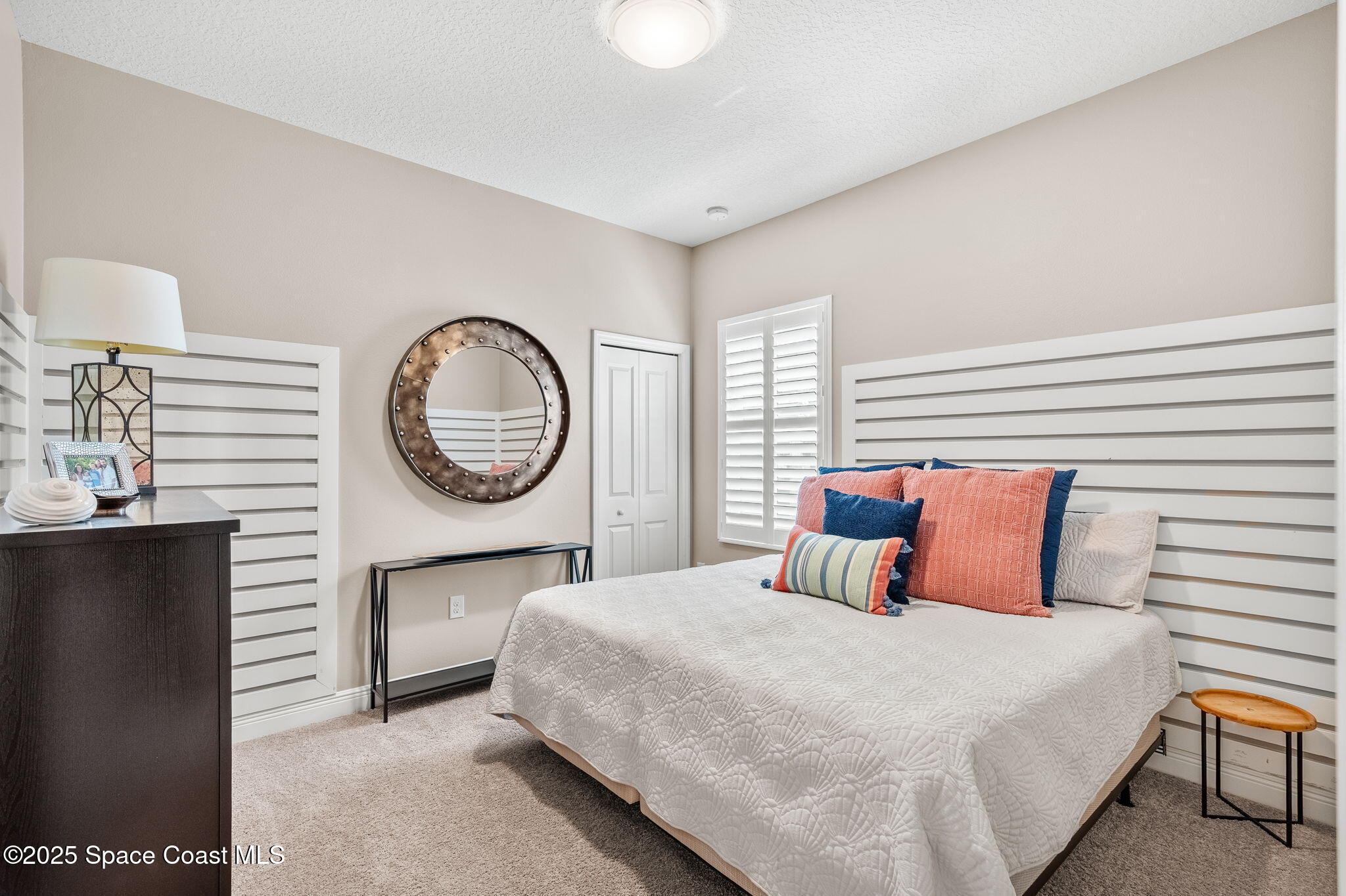 4310 Alamanda Key Drive Melbourne, FL 32901 - Photo 18 of 43 a bedroom with a large bed and a chandelier