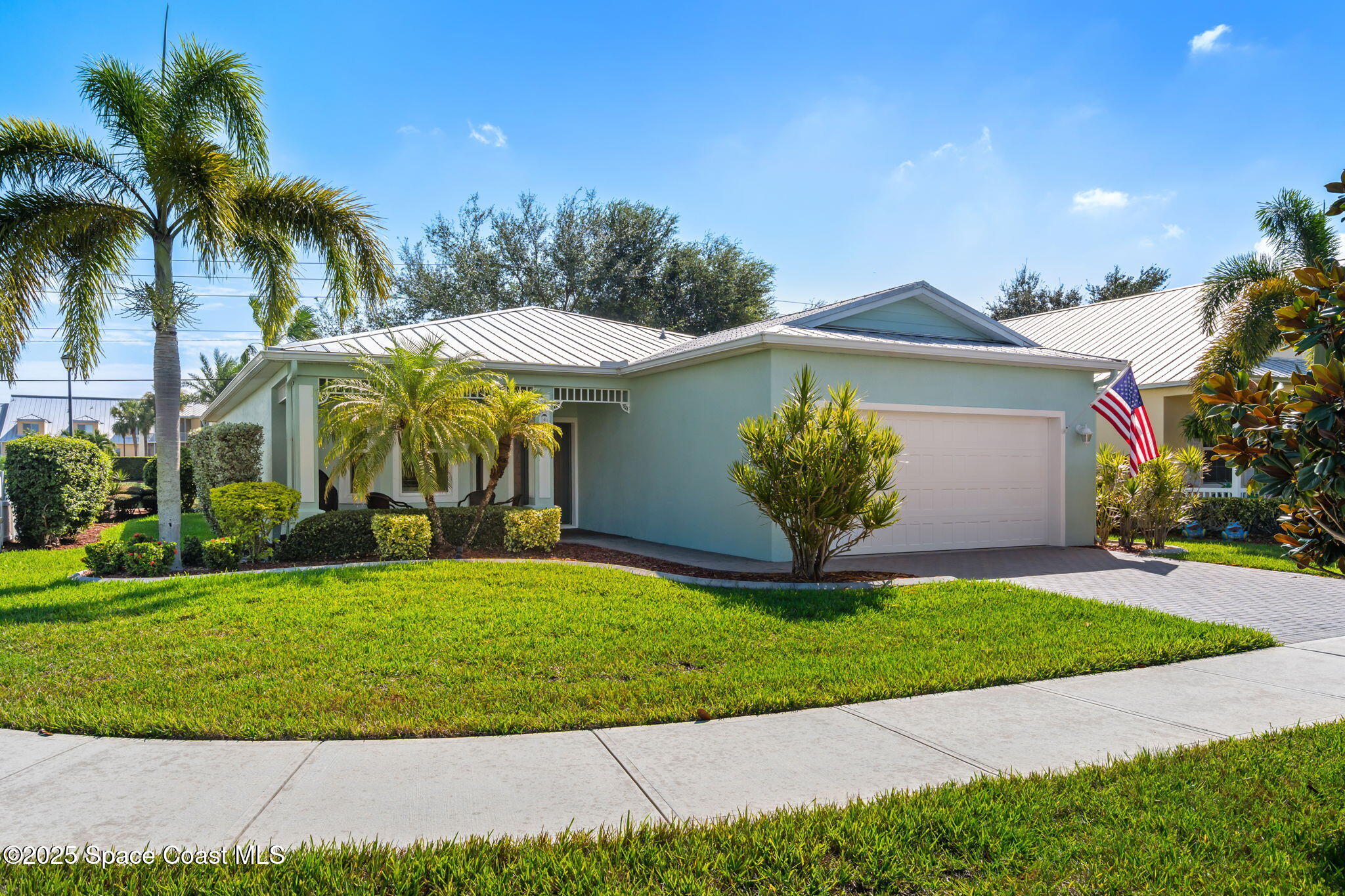 4310 Alamanda Key Drive Melbourne, FL 32901 - Photo 2 of 43 a view of a house with a yard and palm trees