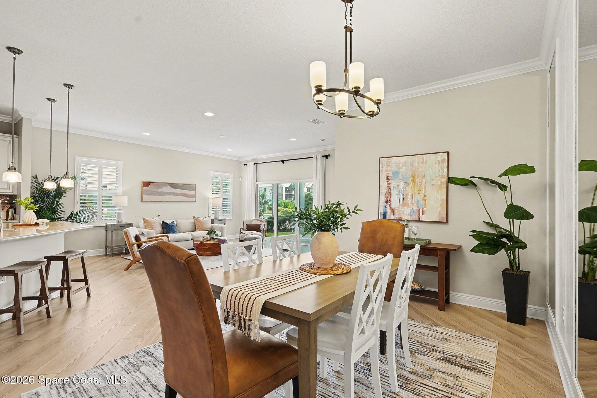 4310 Alamanda Key Drive Melbourne, FL 32901 - Photo 9 of 43 a view of a dining room with furniture window and wooden floor