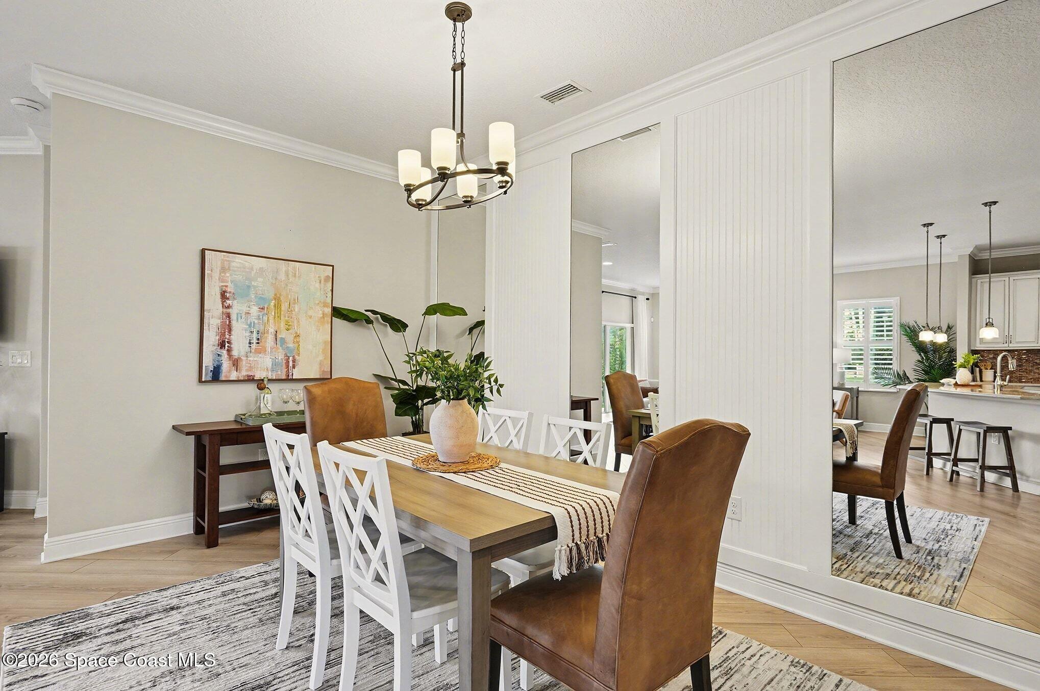 4310 Alamanda Key Drive Melbourne, FL 32901 - Photo 10 of 43 a view of a dining room with furniture window and wooden floor