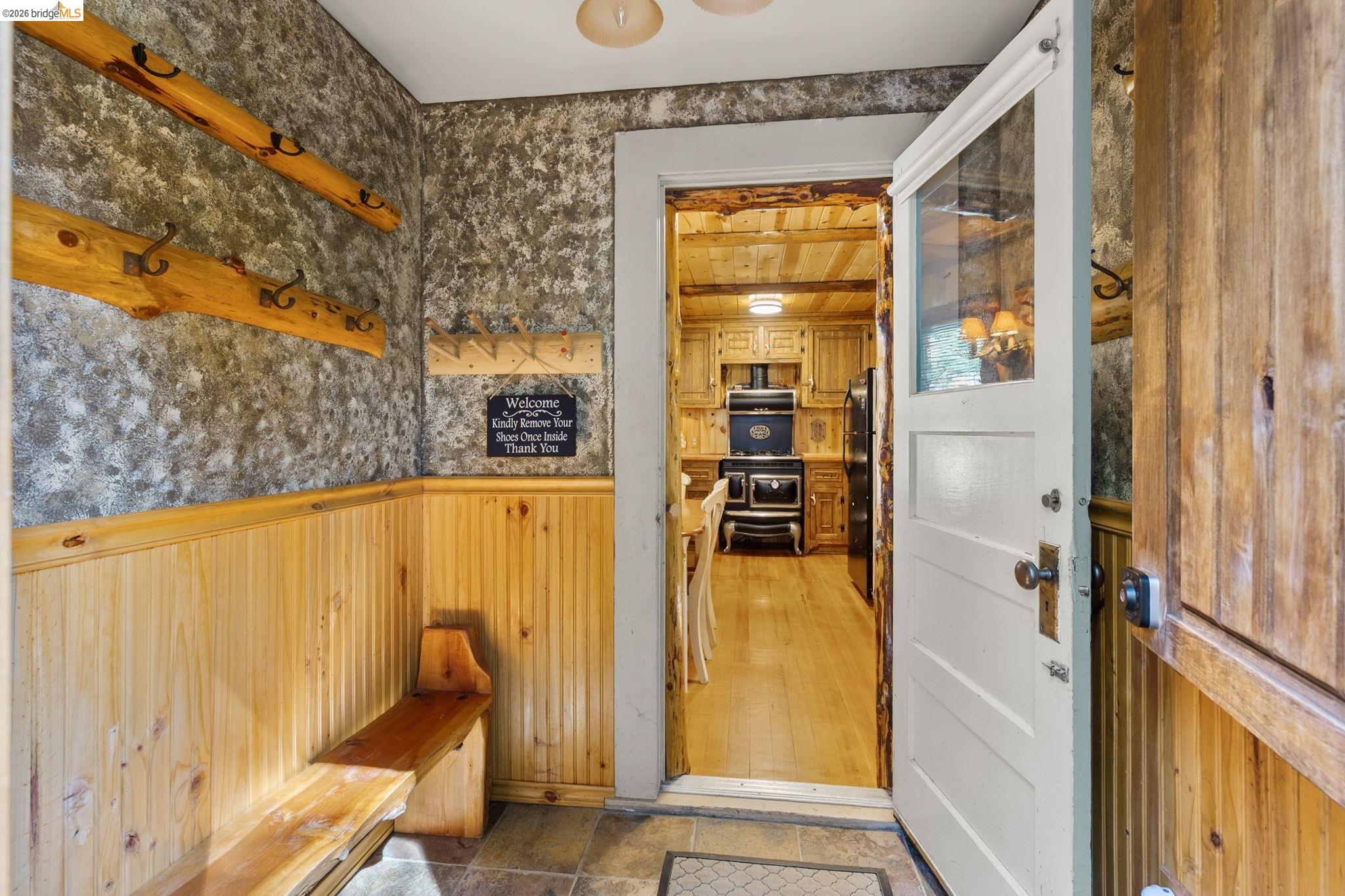 25972 Long Barn Road Long Barn, CA 95335 - Photo 6 of 36 Entryway featuring wood-finish beadboard wainscoting, a bench and lots of pegs for hanging your summer and winter play clothes and equipment.