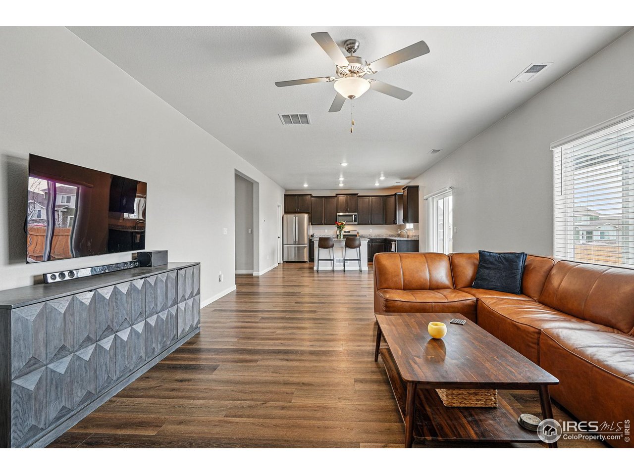 2310 Angus Street Mead, CO 80542 - Photo 11 of 39 a living room with furniture and a flat screen tv