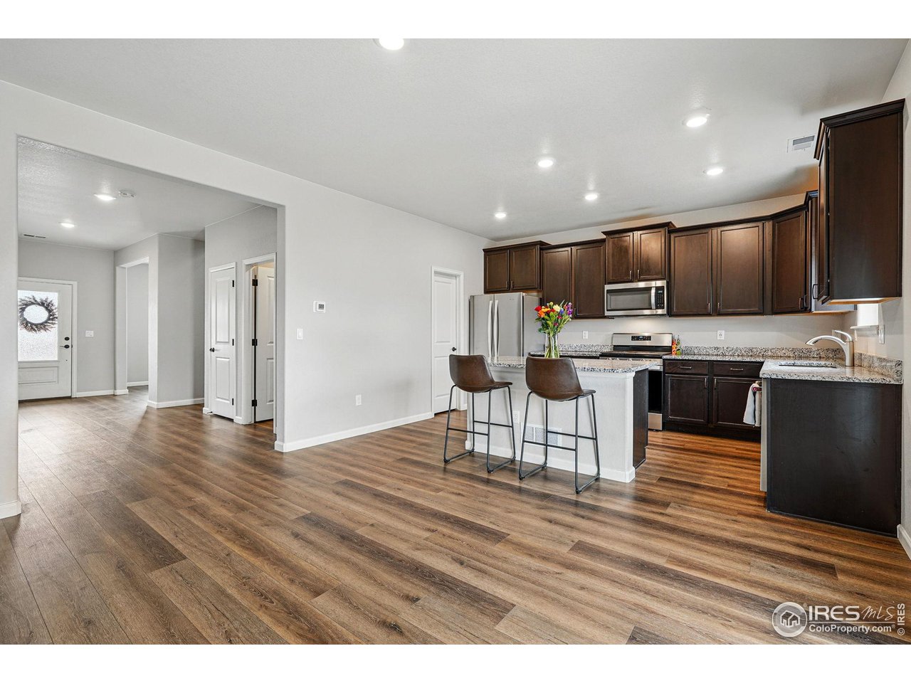 2310 Angus Street Mead, CO 80542 - Photo 14 of 39 a living room with stainless steel appliances kitchen island granite countertop furniture and a view of kitchen