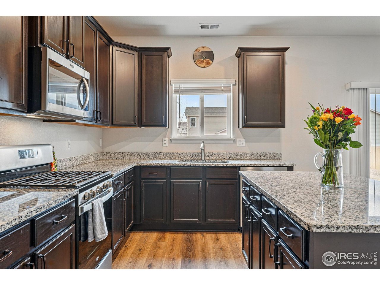 2310 Angus Street Mead, CO 80542 - Photo 15 of 39 a kitchen with stainless steel appliances granite countertop a sink stove and refrigerator