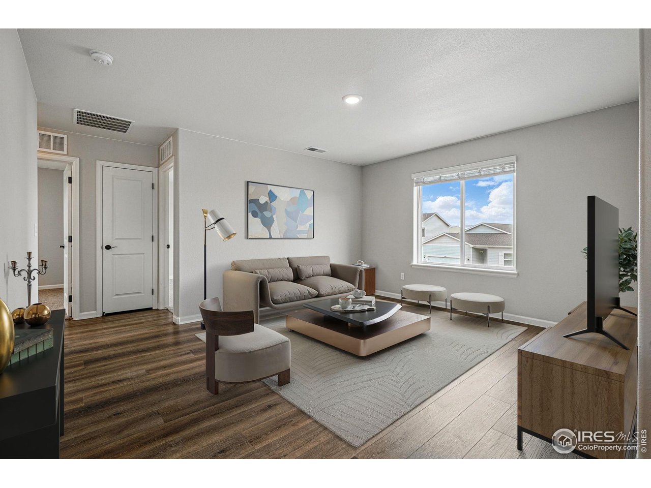 2310 Angus Street Mead, CO 80542 - Photo 17 of 39 a living room with furniture and a flat screen tv