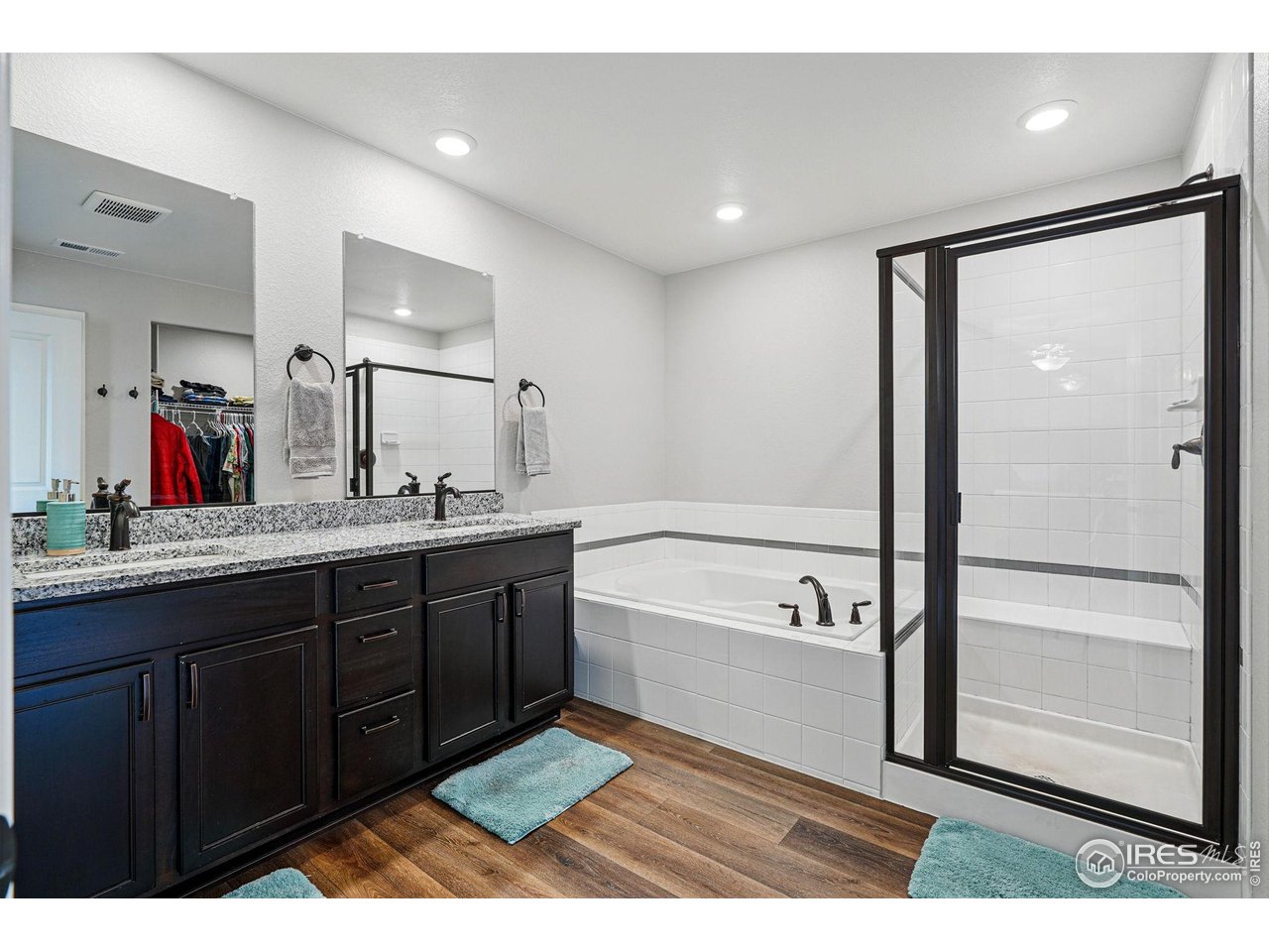 2310 Angus Street Mead, CO 80542 - Photo 23 of 39 a spacious bathroom with a tub shower vanity and a sink