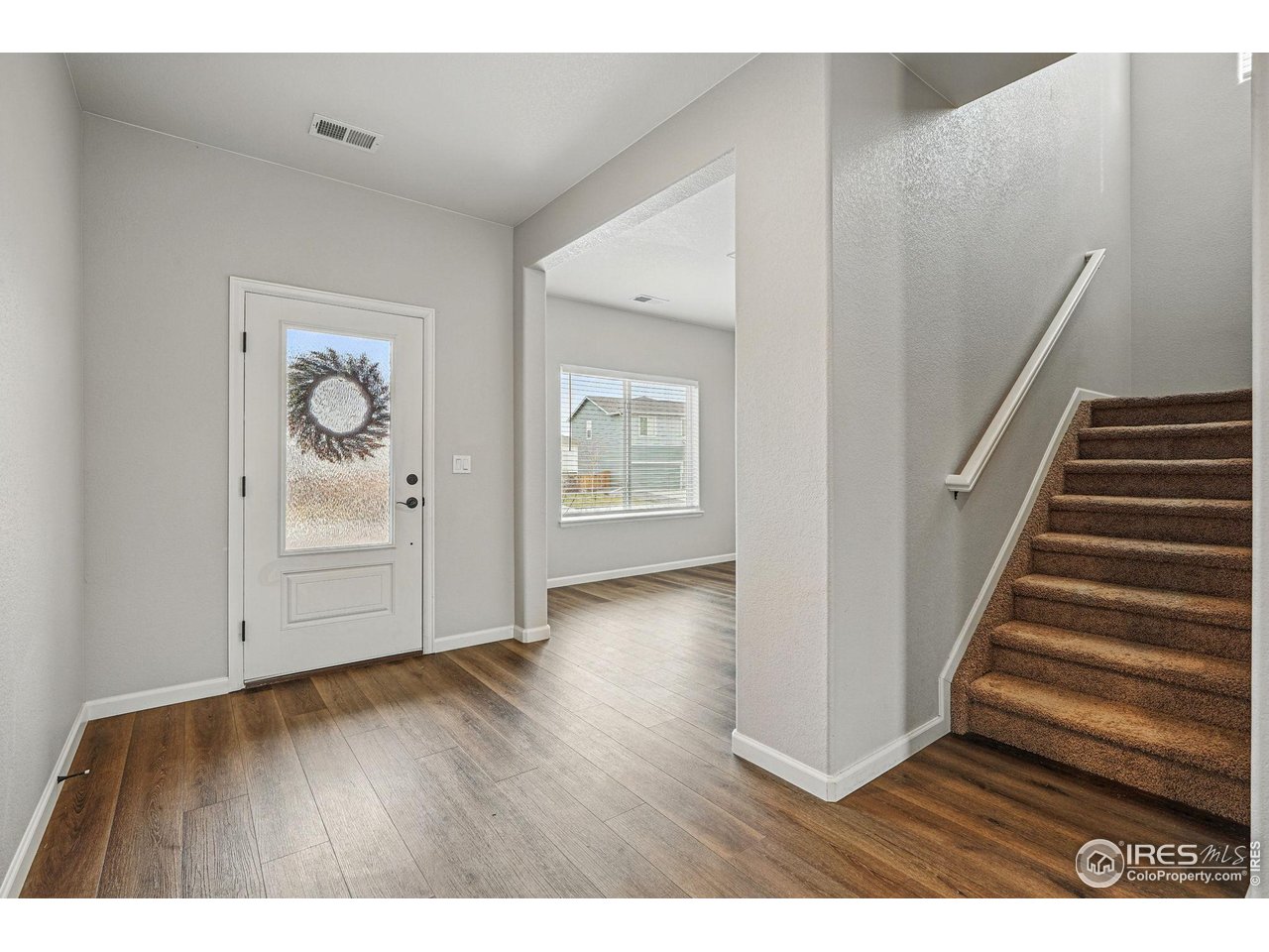 2310 Angus Street Mead, CO 80542 - Photo 3 of 39 a view of an empty room with wooden floor and stairs