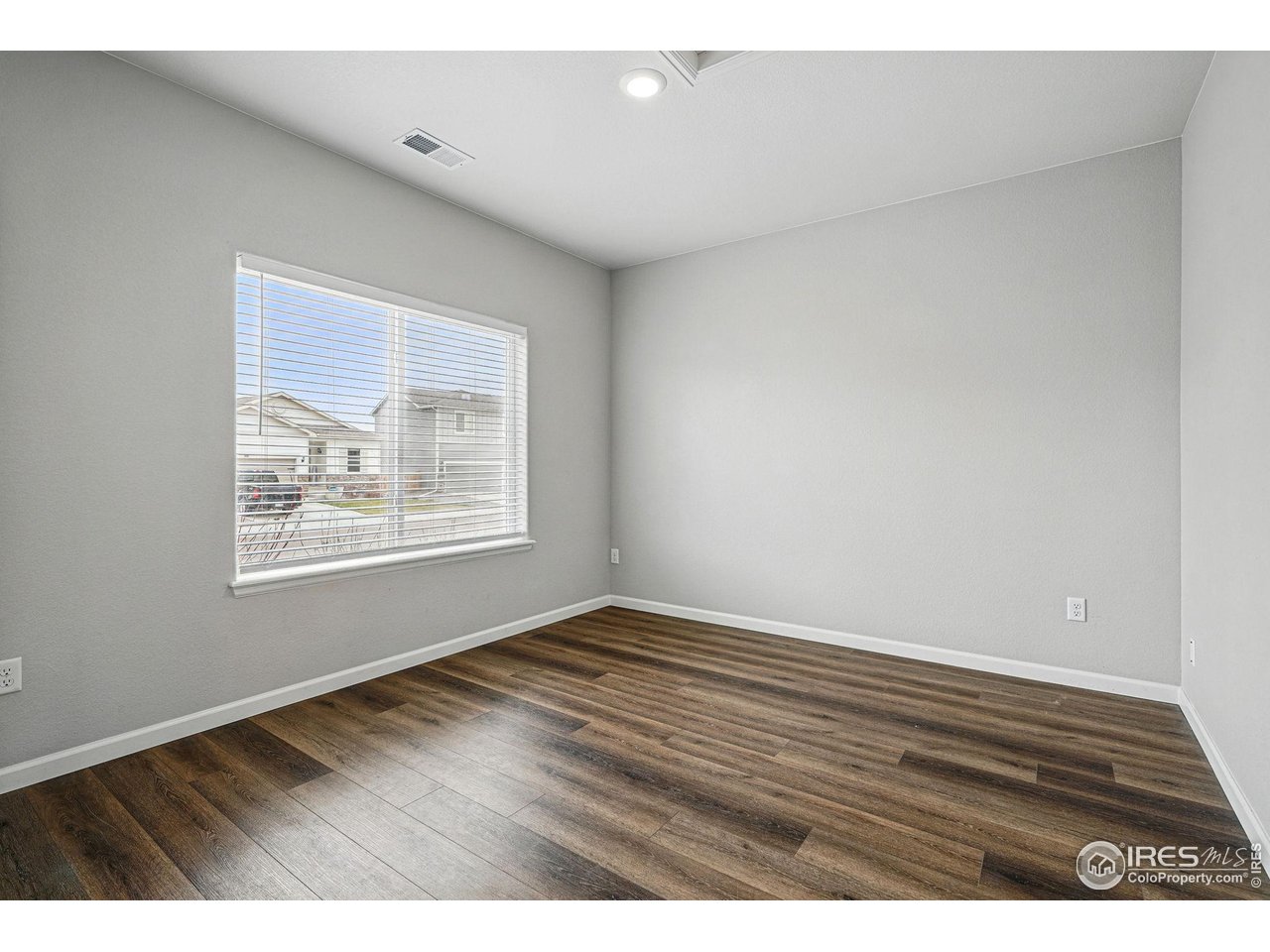 2310 Angus Street Mead, CO 80542 - Photo 5 of 39 a view of an empty room with wooden floor and a window