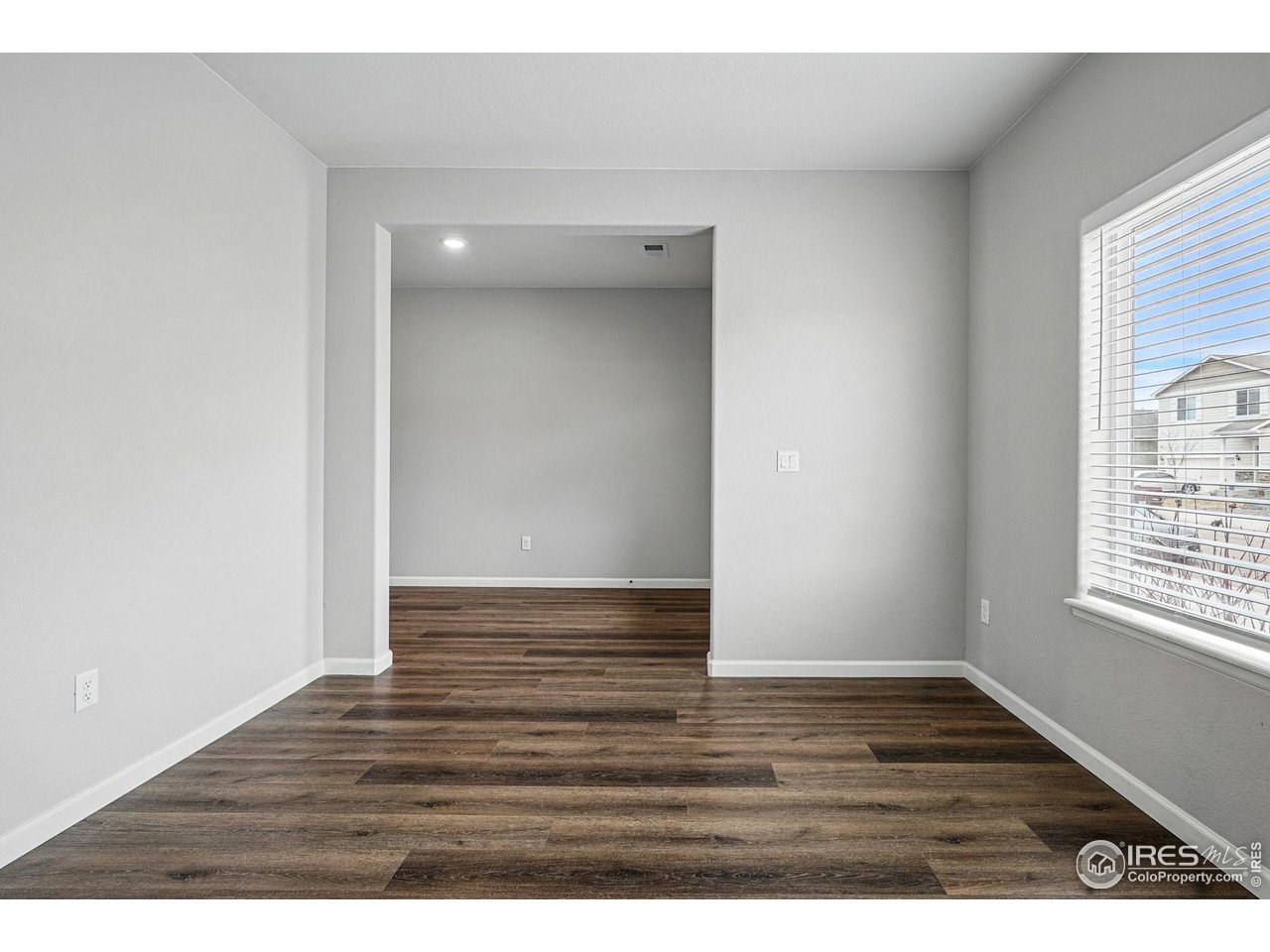 2310 Angus Street Mead, CO 80542 - Photo 6 of 39 a view of an empty room with wooden floor and a window